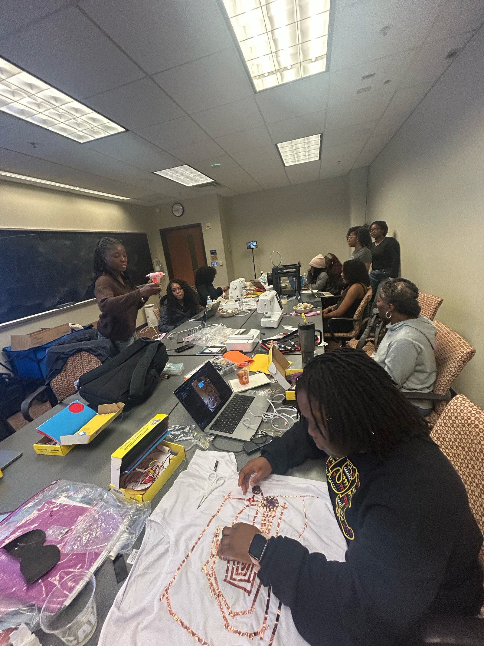 DETOUR Lab members working together at a table on e-textile prototypes